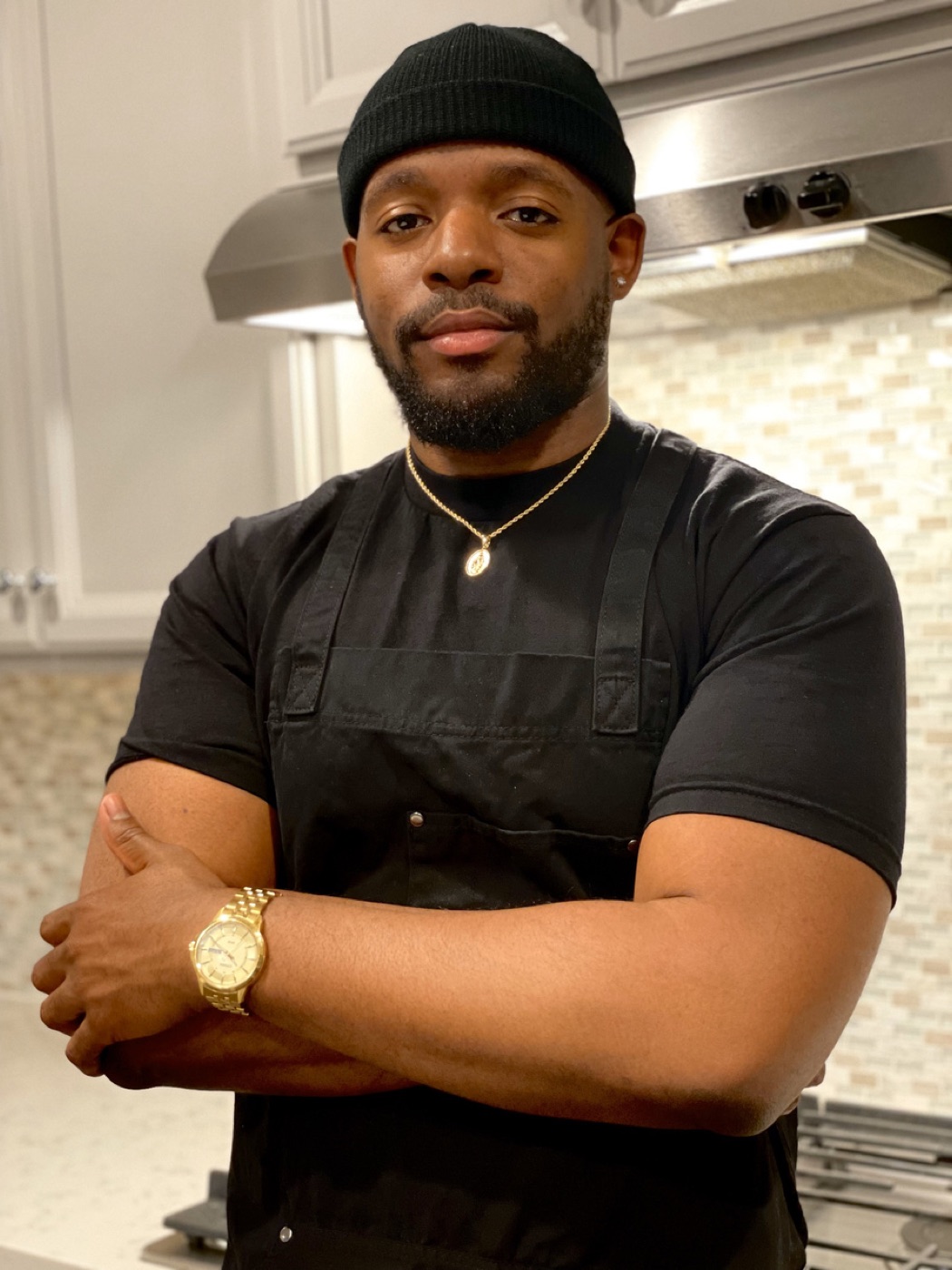 Davon Moseley in his kitchen, arms crossed