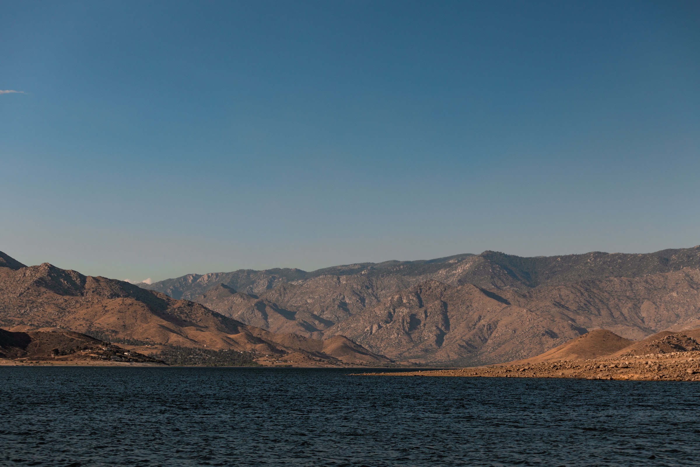 Open water against dry mountains at first light