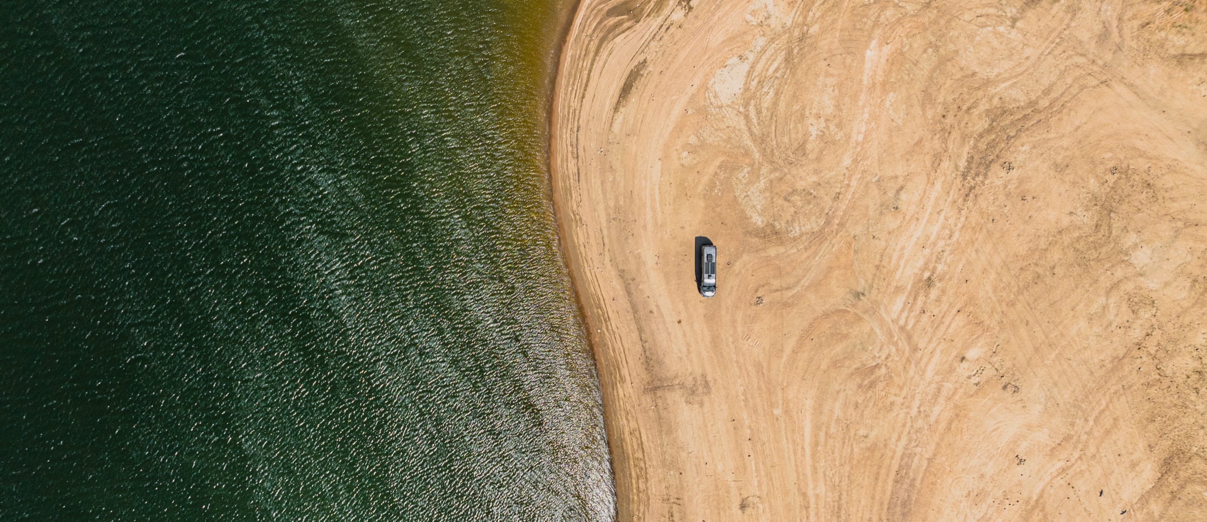 Aerial view of the production van parked on a lakeshore
